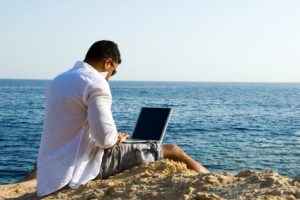 Advisor with laptop at beach